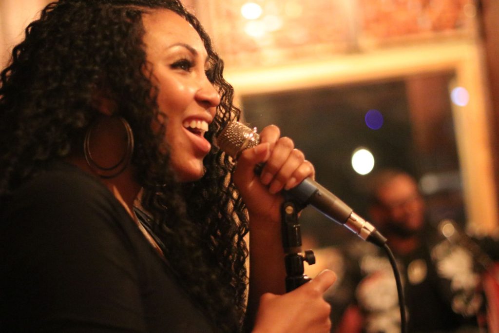 Chaneé singing during a live performance